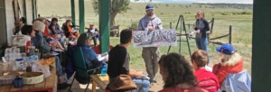 Instructor showing painting to students in a writing workshop